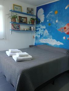 a bedroom with a bed with towels on it at La casa de Emma in Cordoba