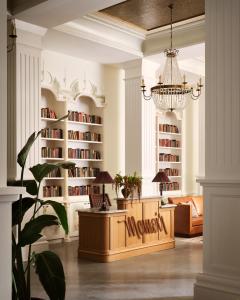 a living room with a large book shelf at Memoir Warehouse District in New Orleans