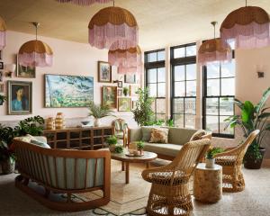 a living room with a couch and chairs and windows at Memoir Warehouse District in New Orleans