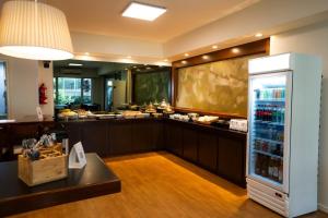 a kitchen with a refrigerator filled with drinks at Aparthotel Trianon Recoleta in Buenos Aires
