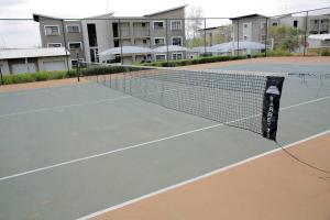 Tennis ja/või seinatennis majutusasutuses Stunning 1-bedroom self check-in condo with pool või selle läheduses