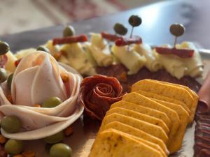 a plate of food with crackers and vegetables on it at Checkmate in Tešanj