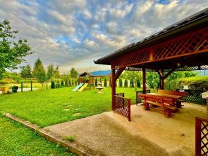 a picnic shelter with a picnic table in a park at Stay and Chill house in Doglodi