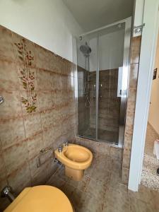 a bathroom with a toilet and a shower at La Ginestra in Roccascalegna +17 photos