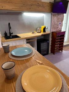 a kitchen with two plates on a wooden table at Primus Suite in Ceglie Messapica +38 photos
