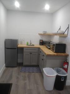a kitchen with a counter and a sink and a refrigerator at Vermont Suites in South Burlington