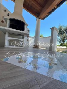 an outdoor kitchen with an outdoor oven on a patio at Villetta Roberto Le Macine di Charme - Pugnochiuso Resort in Vieste