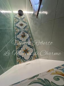 a bathroom with a toilet and a tile floor at Villetta Roberto Le Macine di Charme - Pugnochiuso Resort in Vieste