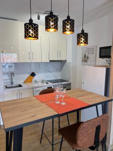 a kitchen with a table with wine glasses on it at Garden city apartment privado in Playa Fañabe