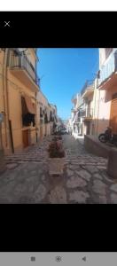 an empty street in a city with buildings at appartamento gioioso in Castellammare del Golfo +3 photos