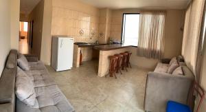 a living room with a couch and a kitchen at Hotel Belamar in La Libertad