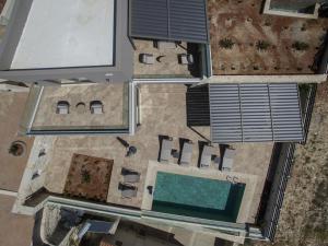 an overhead view of a house with a swimming pool at Villas Paradise in Kalamaki by South Cretan Villas in Kalamaki