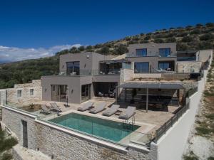 an aerial view of a house with a swimming pool at Villas Paradise in Kalamaki by South Cretan Villas in Kalamaki