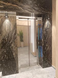 a bathroom with a glass shower in a building at Apartman Rentals Lux KG 2 in Kragujevac