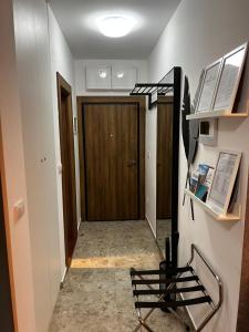a hallway with a wooden door and a stair case at Apartman Rentals Lux KG 2 in Kragujevac