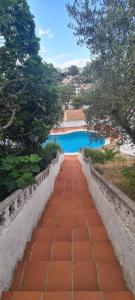 a brick path leading to a swimming pool at Chalé Almaria in Oliva