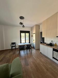 a kitchen and living room with a table and chairs at Villa Shega in Borsh