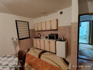 a kitchen with a counter and a microwave at Apartment Happy Corner in Visoko