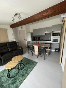 a living room with a couch and a table at La cigale des cantarelles in Mornas