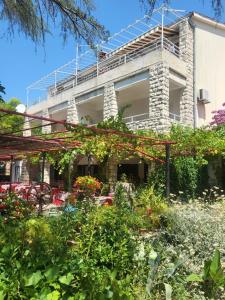 a garden in front of a building at Margaret 150 METERS TO THE BEACH in Banjole