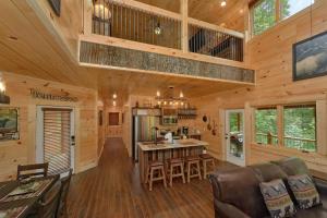 a living room and kitchen in a wooden cabin at Poolin Around in Waldens Creek
