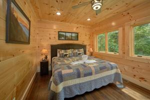 a bedroom with a bed in a log cabin at Poolin Around in Waldens Creek +45 photos