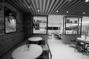 a restaurant with tables and chairs in a room at Hotel Migliore Seoul in Seoul