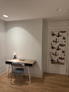 a desk with a lamp next to a wall with a door at Tekija Central Stay Apartment in Sarajevo