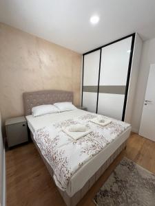 a bedroom with a bed and a large window at Sunset Home Mostar in Mostar