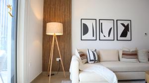 a living room with a couch and a lamp at Cozy 1BR Apartment on Yas Island - Relaxing Stay Near Yas Mall & Ferrari World in Abu Dhabi +35 photos