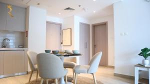 a kitchen and dining room with a table and chairs at Oasis 1BR -Yas Island Spacious Stay in Abu Dhabi +34 photos