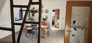 a kitchen and dining room with a table and a ladder at Charmante Ferienwohnung in Zell an der Mosel