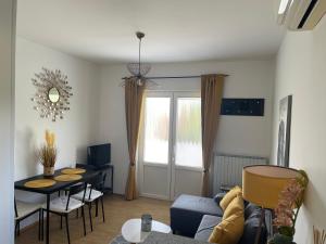 a living room with a blue couch and a table at Rab Island Apartmets - Palit in Rab