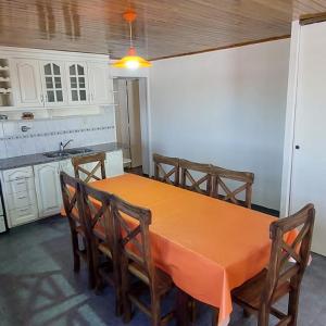 a kitchen with a table and chairs and a kitchen with white cabinets at Casa bosque de Sol in Malargüe +6 photos