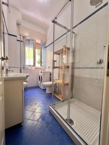 ein Badezimmer mit Dusche, Waschbecken und Toilette in der Unterkunft Viareggio on the Beach - Apartment in Viareggio