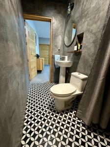 a bathroom with a toilet and a sink at Departamento en MossoCafe Oaxaca in Oaxaca City