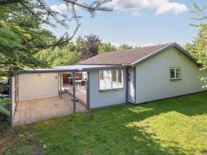 a small white house with a patio at 4 star holiday home in Gedsted-By Traum in Gedsted