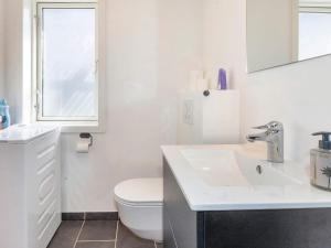 a white bathroom with a toilet and a sink at 4 star holiday home in Gedsted-By Traum in Gedsted +31 photos