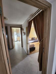 a hallway leading to a bedroom with a bed in a room at Agadir anza résidence miftah sahil in Agadir
