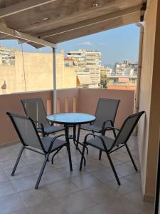 a table and chairs on a balcony with a view at Demi DS, E1 in Agrinio +10 photos