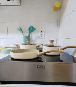 a kitchen with several pots and pans on a counter at Lemontree in Seoul
