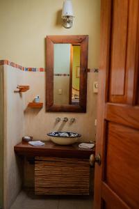 a bathroom with a sink and a mirror at Hotel Boutique Casa San Angel in Mérida