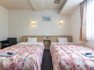 Ein Bett oder Betten in einem Zimmer der Unterkunft Tabist Annex Matsumi