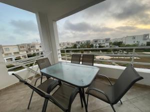 a table and chairs on a balcony with a view at شاليه in El Alamein