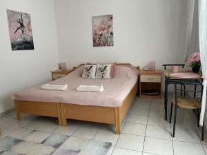 a small bedroom with a bed and a table at Rab Island Apartmets - Palit in Rab +52 photos