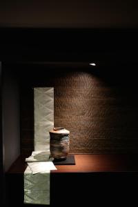 a vase sitting on a table next to a wall at Noku Kyoto in Kyoto +50 photos