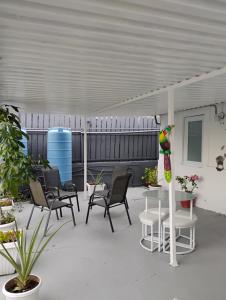a group of chairs and a table on a patio at Black & White Comfort Studio in San Juan