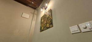 a painting hanging on a wall with a light at The Century Aigoh Hotel in George Town +103 photos