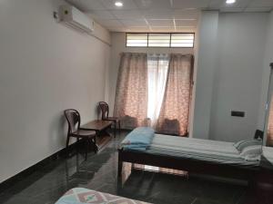 Postel nebo postele na pokoji v ubytování Mansons Homestay