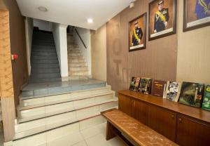 a room with a staircase with a bench and some pictures at Sun Inns Skudai in Skudai